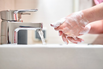 Washing of hands with soap under water