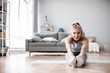 © BestForYou - Young attractive woman in sportswear doing exercise in living room.