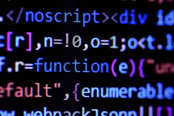 Wall Mural - close-up of minified javascript file. computer programming source code for html website development.