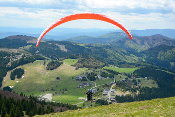 Donovaly, Slovakia - May 10, 2019:  People do paragliding sport in the mountains