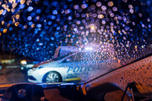Spain, Madrid, Interior Of Car Parked In Front Of Patrolling Police Car At Night