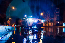 Spain, Madrid, Surface View Of Police Car Driving In Middle Of Rainy Night