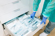 © Westend61 - Doctor taking sterile instruments form cabinet