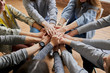 © Roman - top view on people hands holding together, friendly team work at meeting. club of anonymous alcoholics