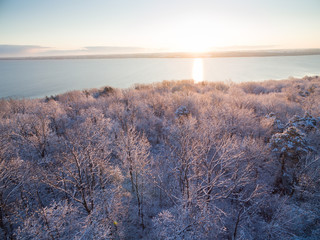 Wall Mural - Sunrise over lake and top of forest