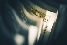 Close-up Of American One Hundred Dollar Bills In Darkroom