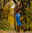 © Andrey_Arkusha - Full body portrait of a young beautiful woman in blue jeans in autumn park