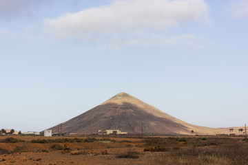 Symmetric volcanic mountain in Fuerteventura island. Natural arid landscape on dry area in Canary Islands, Spain