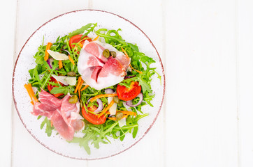 Wall Mural - Fresh homemade salad with arugula, jamon, rucola, tomatoes, parmesan.