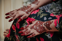 Midsection Of Woman With Henna Tattoo On Hands