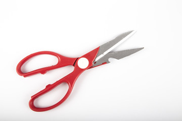 Scissors with red plastic handles, on a white background.