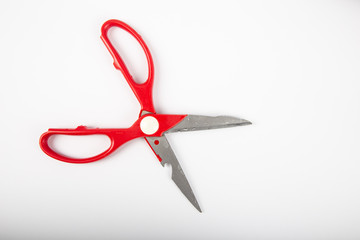 Scissors with red plastic handles, on a white background.