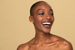 Happy nude black woman against a beige background