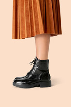 Woman In A Skirt Wearing Combat Boots