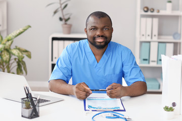 Male African-American doctor working in clinic