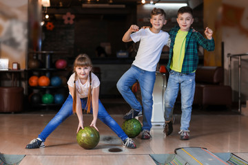 Wall Mural - Little children playing bowling in club