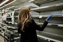 Woman With Empty Shelves In A Supermarket During Coronavirus Pandemic