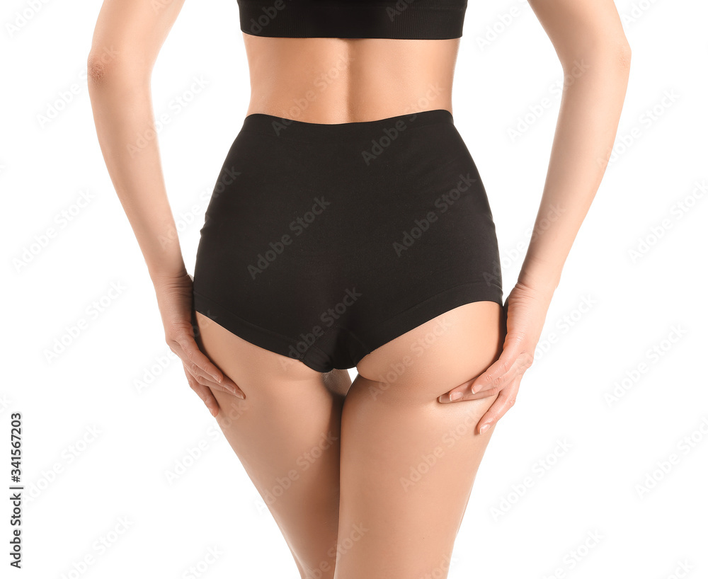 Beautiful young woman in underwear on white background. Concept of cellulite