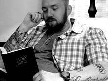 Man Reading Bible While Sitting At Home
