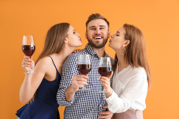 Poster - Happy people with glasses of wine on color background