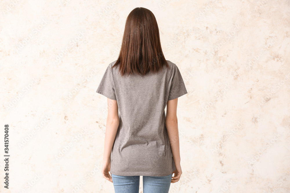 Woman in stylish t-shirt on light background
