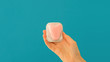 Closeup woman holding a heart shaped swab in her hand holding a sanitary tampon for sex blue background