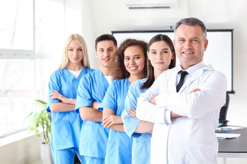 Wall Mural - Male lecturer with medical students in university