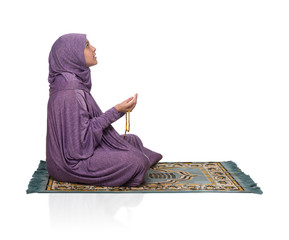 Wall Mural - Beautiful Arabic Girl Praying for Allah Wearing Muslim Clothes