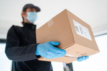 Home Delivery Shopping Box Man Wearing Gloves And Protective Mask Delivering Packages At Door.
