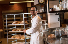 Portrait Of Young Male Baker Standing At Bakery.