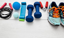 The Fitness Tools And  A Equipment On The Wooden Floor. Concept Of Home Physical Training And Staying At Home