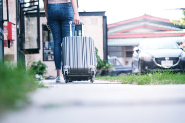 Traveler woman carrying luggage. Tourist walking with Suitcases Travel lifestyle concept.