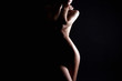 Leinwandbild Motiv Nude Woman silhouette under light in the dark