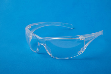 Glasses or safety glasses. Protective clothing for protecting human eyes. One object isolated on a blue background.