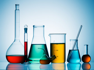 Wall Mural - different laboratory glassware with color liquid and with reflection