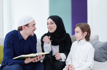 Wall Mural - muslim family reading Quran and praying at home