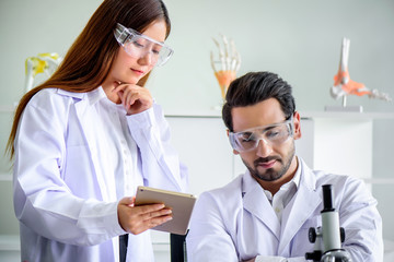 Wall Mural - attractive happiness scientist woman show her report to chief but he sleeping. medical, pharmaceutic