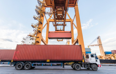 Container Cargo freight ship with working crane loading bridge in shipyard at Logistic Import Export Zone background. imports, exports, logistics, transportation, dock or supply chain concepts