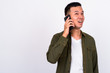 © Ranta Images - Portrait of happy young Asian man talking on the phone