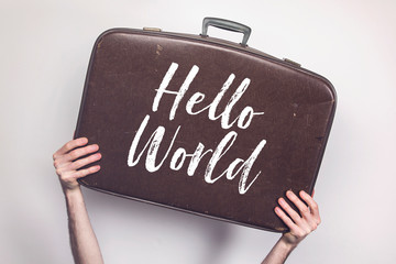 Wall Mural - Hello World message on a vintage travel suitcase