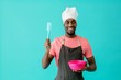 © Carlos David - Portrait of a smiling young male cook holding spatula and bowl looking to side at copy space