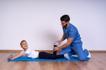 A picture of a physio therapist giving a foot massage over white background