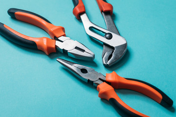 Wall Mural - group a bunch of tools with orange handles on a blue background laid out neatly close