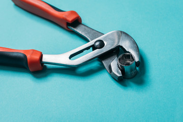 Wall Mural - metal pliers of metal on a blue background laid neatly close