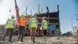 © Gorodenkoff - Diverse Team of Specialists Inspect Commercial, Industrial Building Construction Site. Real Estate Project with Civil Engineer, Investor and Businesswoman. In the Background Skyscraper Formwork Frames