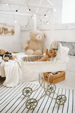 Old Teddy Bears Sitting In Vintage Baby Carriage With Toys