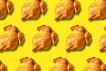 Wall Mural - colorful pattern of roasted chicken or turkey on yellow background. top view. creative design for pa