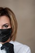 © sun_house_ann - beautician corrects black medical mask