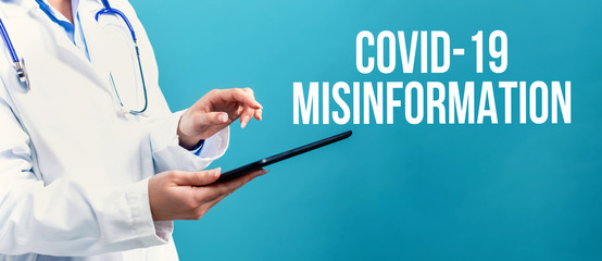 Covid-19 Misinformation theme with a doctor using a tablet computer