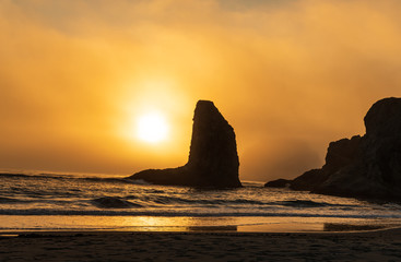 Wall Mural - Orange Sunset silhouettes sea stacks on Bandon Beach in Oregon